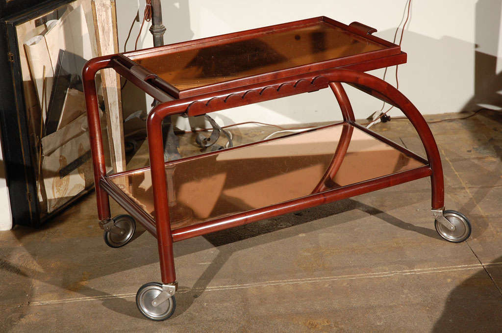 Italian tea cart with rose colored mirrored shelves and removable tray.