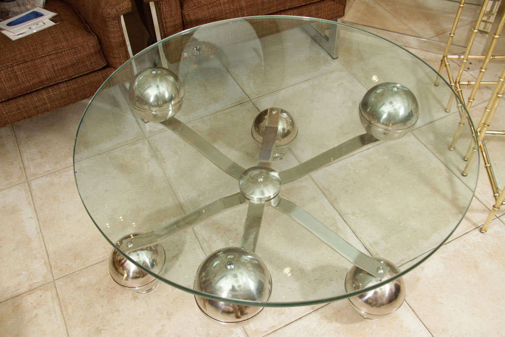 Nickel Circular coffee table with industrial base and glass top