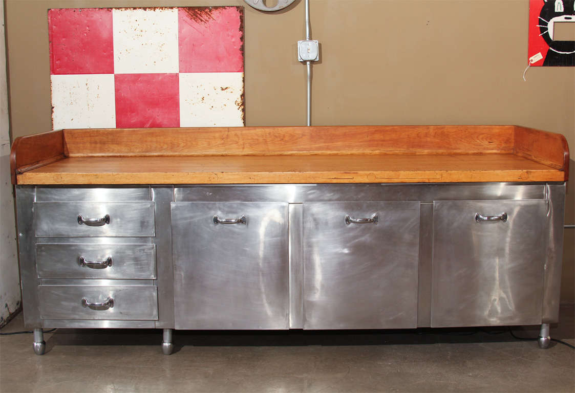 Industrial Stainless Steel bottom with maple baker's top.  Excellent piece for kitchen, retail display, laundry or recycling.  Adjustable bullet feet.