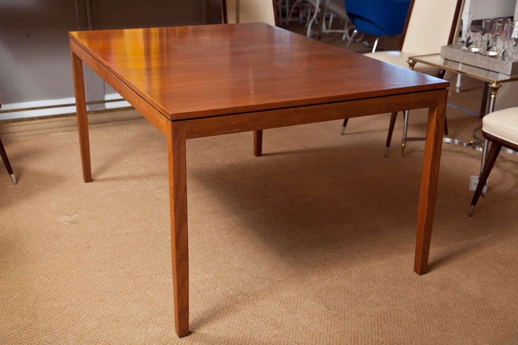 Simple, elegant, walnut, mid-century dining table designed by Florence Knoll. Table includes a 28