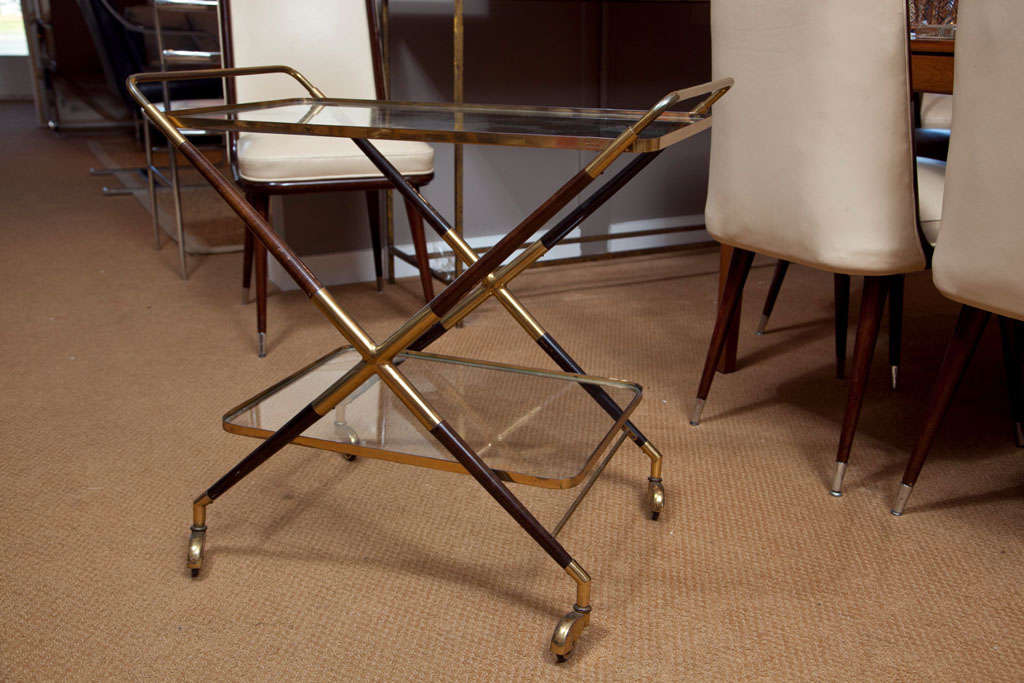 Cesare Lacca attributed beverage cart. Cross-legged brass frame with rosewood elements on casters; two tier glass trays.