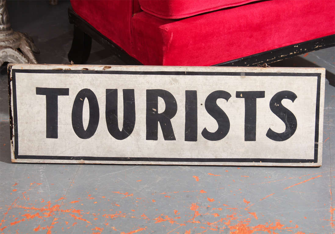 black and white painted tourist sign