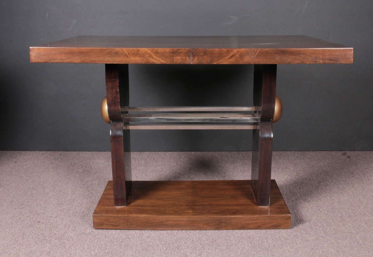 Fine French Art Deco rectangular table featuring book matched walnut veneer with sculptural base joined by polished nickel bronze tubular stretcher.
If necessary, the nickeled mounts can be plated a different finish for an extra charge.
End Tables,