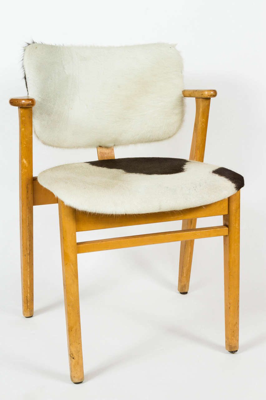 Set of four early Domus Armchairs by Ilmari Tapiovaara. These stackable chairs are upholstered in cowhide. Produced in Finland by Keravan Puuteollisuus and distributed in the U.S. by Knoll, circa 1946