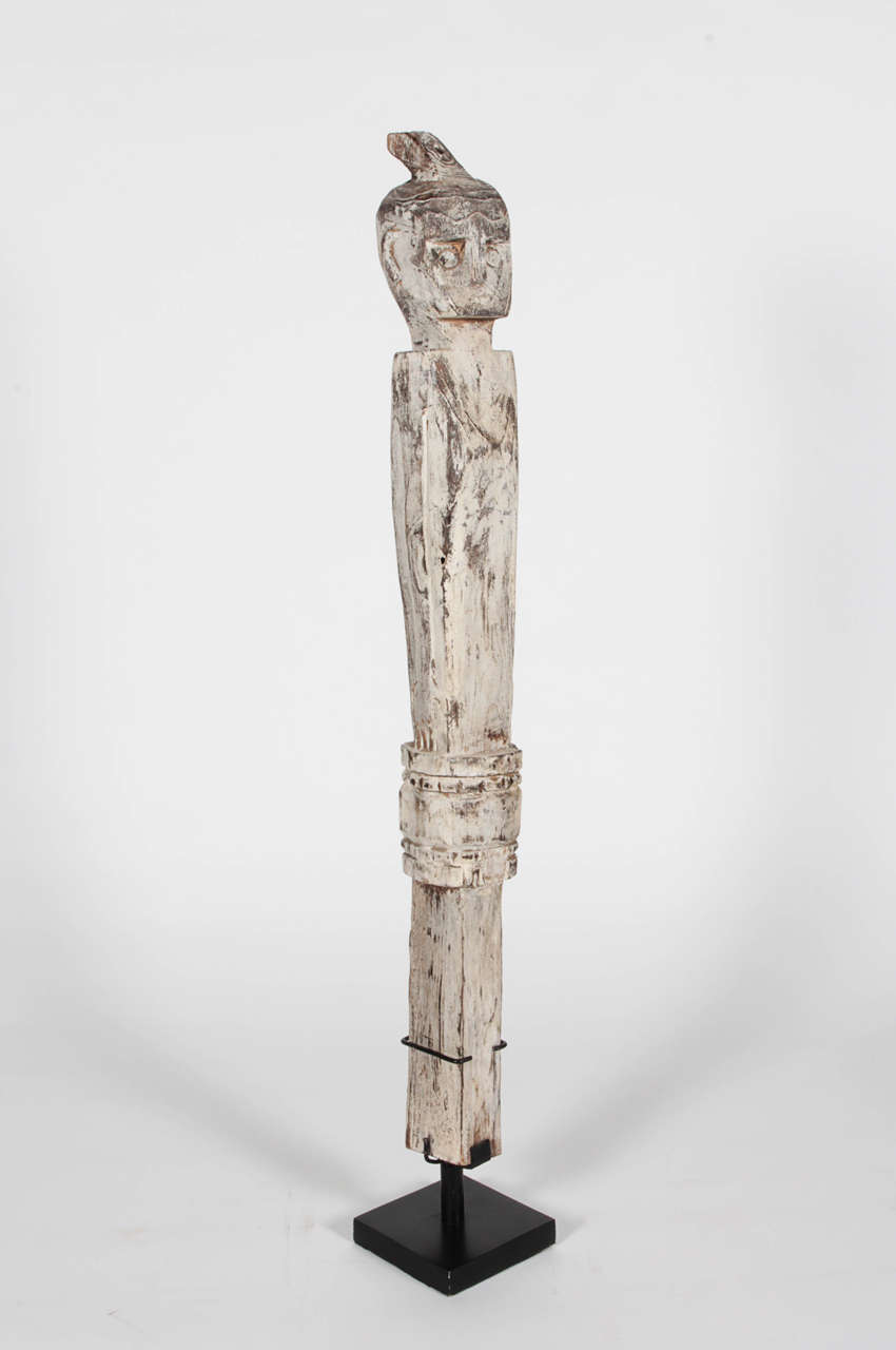 Teakwood figure on Stand from Sumba, Indonesia. Typically placed on the top point of a roof as a protective symbol from evil spirits. Personally selected by Donna Karan for her Urban Zen brand.