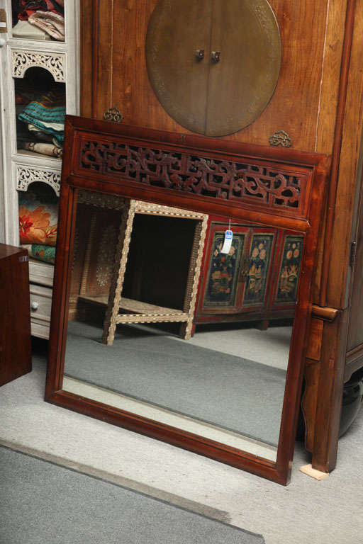 This elm frame rectangular mirror was made in China, where it incorporated an antique Chinese carving into the frame. The simple elm frame showcases the beautiful antique carving featuring traditional Chinese patterns of squares and vegetable