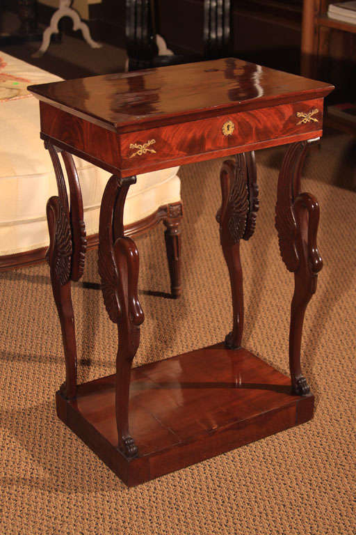 French Restauration Sewing Table

This wonderful mahogany table features a chamfered rectangular top that hinges open.  Inside it reveals a mirrored back and the original candleholder and pin cushion. 

The frienze is bookmatched veneer with the