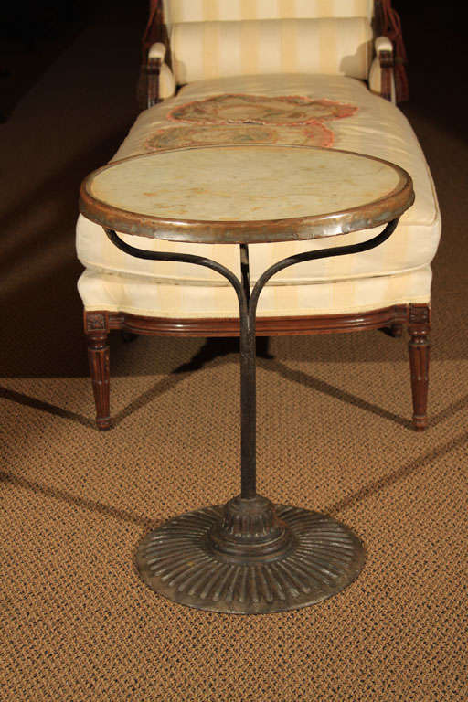 French Bistro Table with Marble Top

This is an original bistro table with white carrara marble on top.  It features the original bronze trim around the marble.

The pedestal leg stands on an iron base that is fluted and weighted which makes it