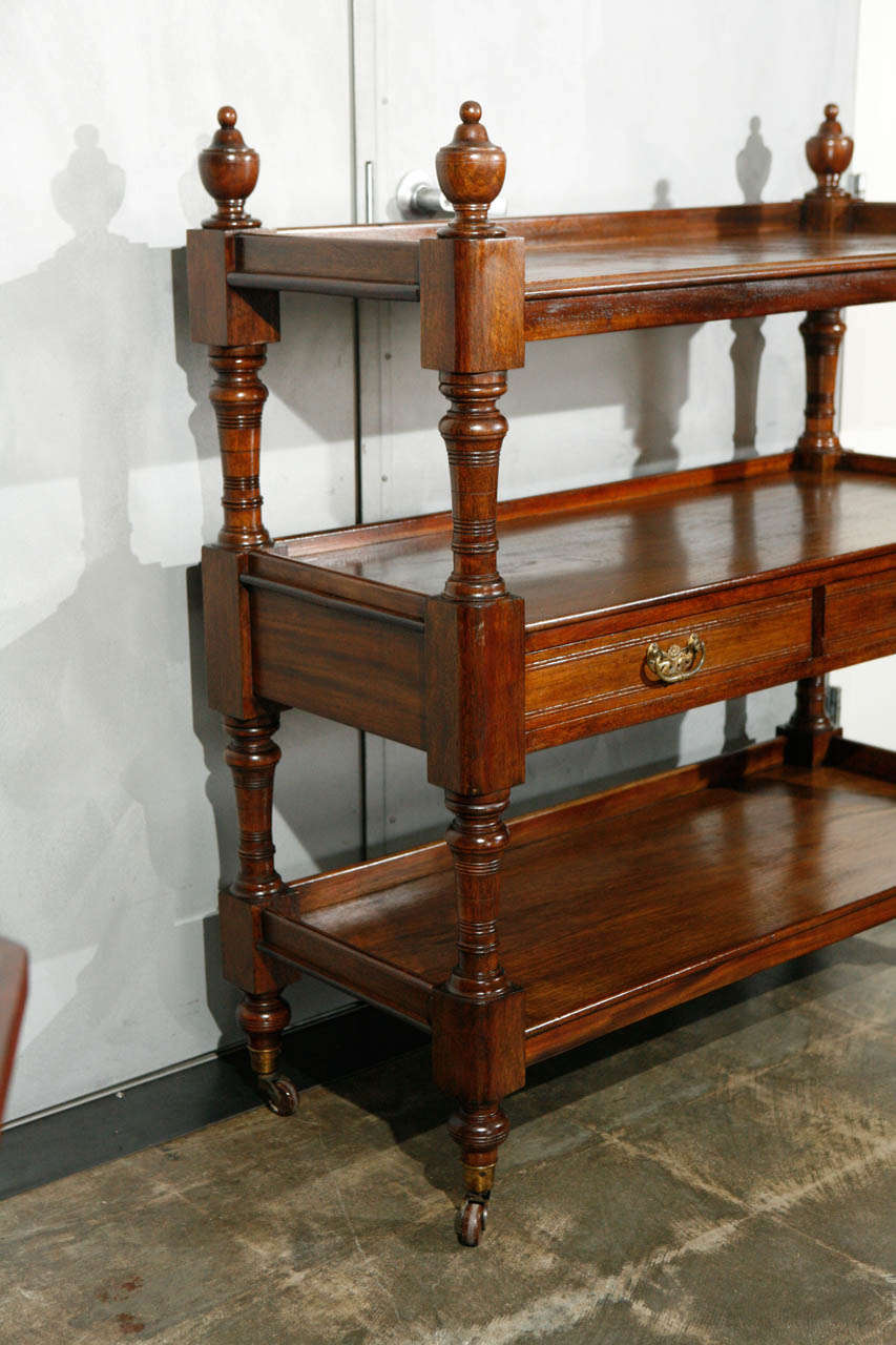 This Is a very nice piece of 19th century English furniture, A perfect piece for displaying dish ware and very useful as a server in your dining room. The piece is made from Mahogany with three tiers, two drawers with brass drop pull handles and