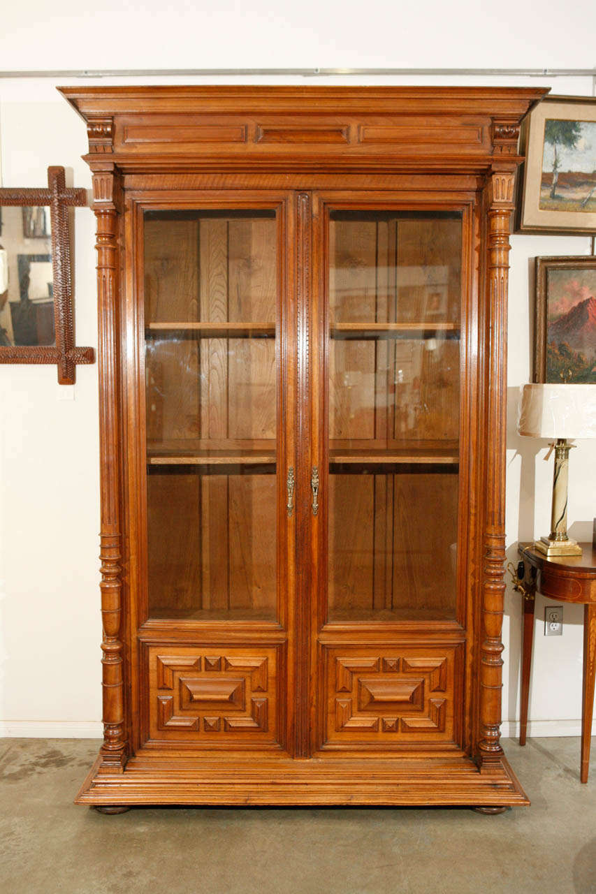 A nicely appointed french oak bibliothèque is an excellent example of Henry II period furniture, displaying exquisite craftsmanship and design details. The cabinet has fielded paneled sides, turned and reeded columns and a decorative cornice at the