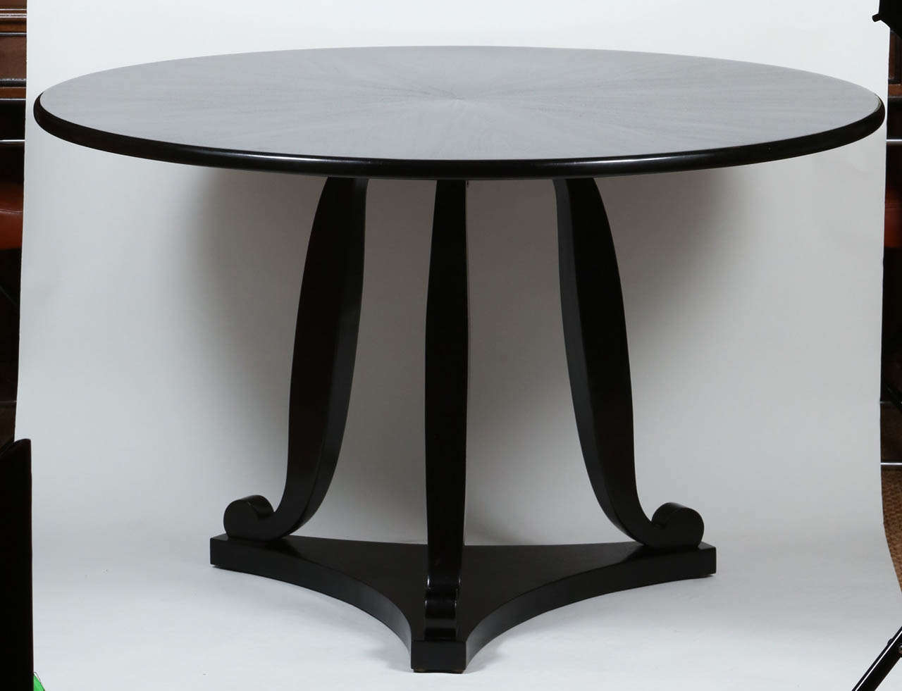 Center table show in ribbon mahogany with an ebonized French polish finish. Details include contrasting inlay on table top, set against a dark ground and Restauration inspired legs. 

Dimensions: 29