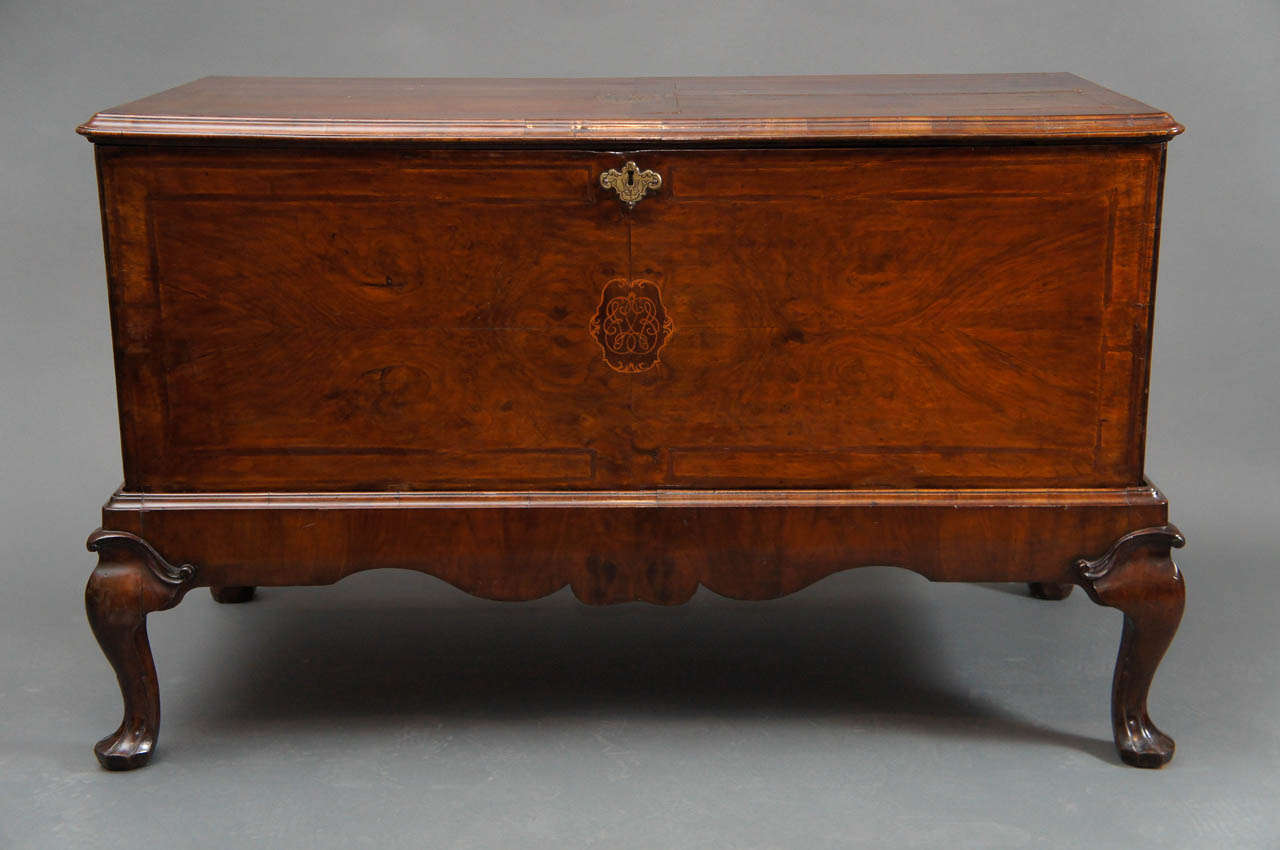 George I style walnut-inlaid blanket chest
Set upon separate stand. Quarter veneered lid with inlaid monogram.