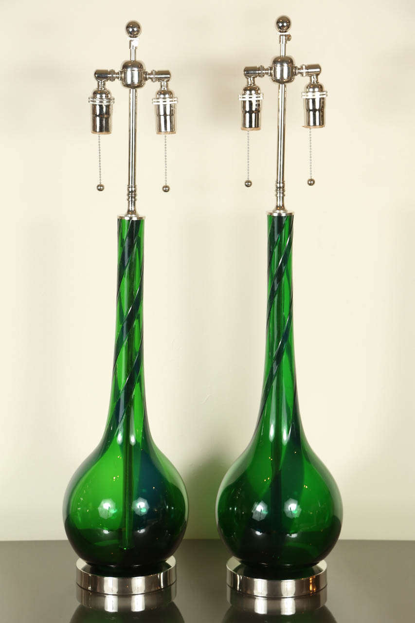 Pair of emerald blown glass table lamps.  They have been newly rewired and fitted with nickel bases and double cluster hardware.