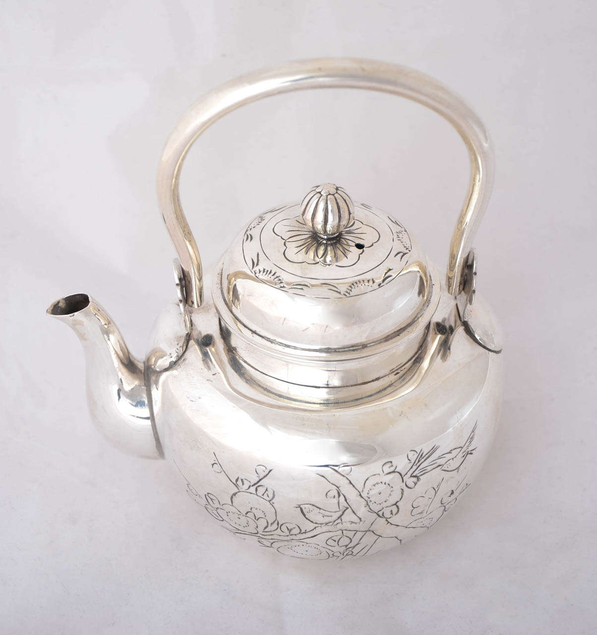 This small Meiji period kettle is a delightful example of Japanese silver. It is 15.5 cms to the top of the handle and weighs 270gms.