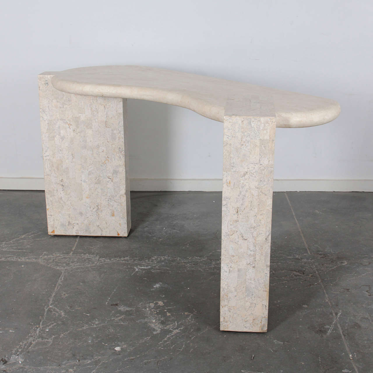 Sculptural console table with free-form top on two architectural bases.