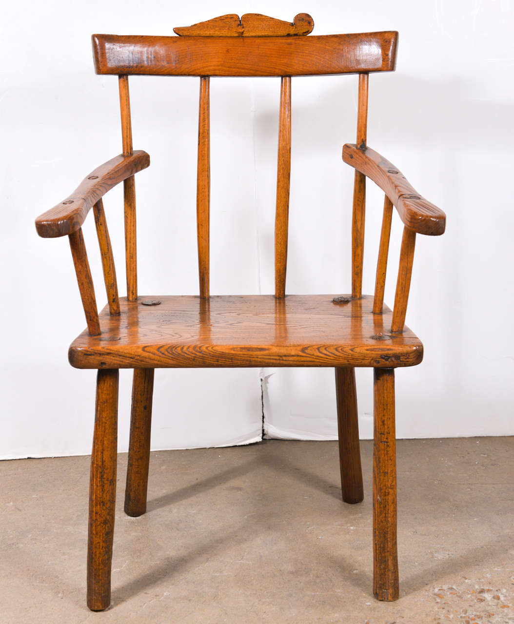 18th century hedge row chair in elm from England. Has the crest detail on top. Beautiful patina, circa 1760.