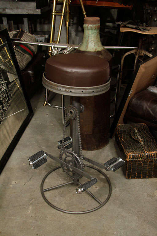 These stools are made from bicycle parts. They may have been made for a club here in NYC. The pedals are stationary to act as the foot rest.