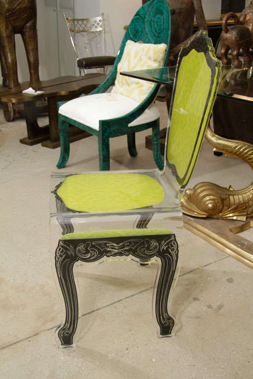 A French lucite chair mixing modern and baroque.<br />
The colors and decoration of this chair make it the <br />
Perfect accent piece