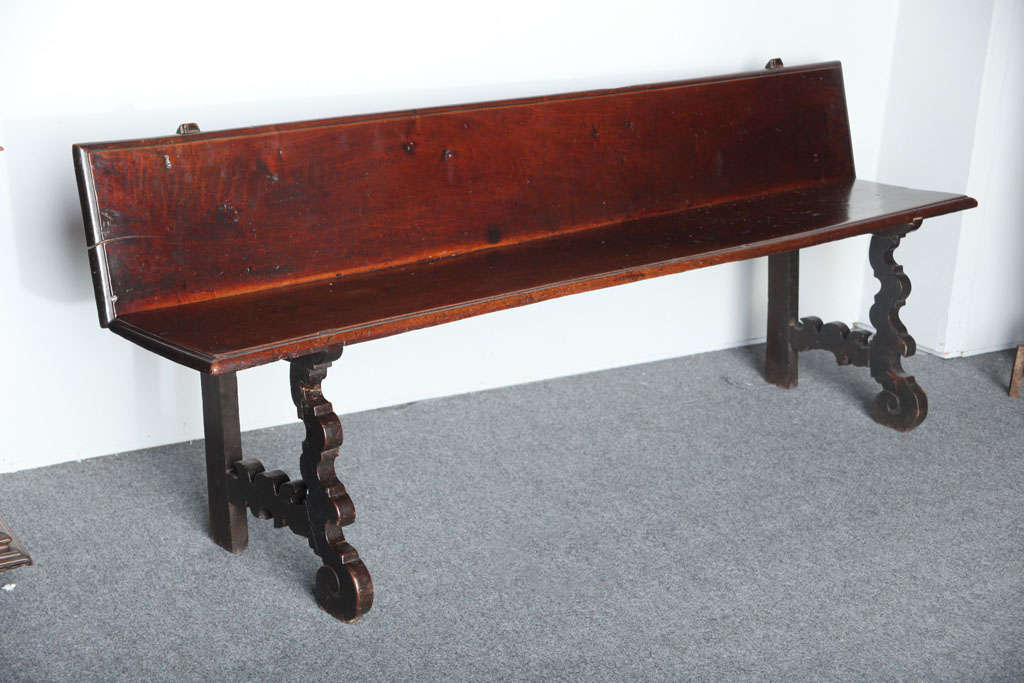 A very rare 17th century Spanish long bench in solid walnut having molded seat and backrest on beautifully shaped cut-out legs. Very few of these benches are left as most were converted into tables in the 19th century. Would work well in an entry