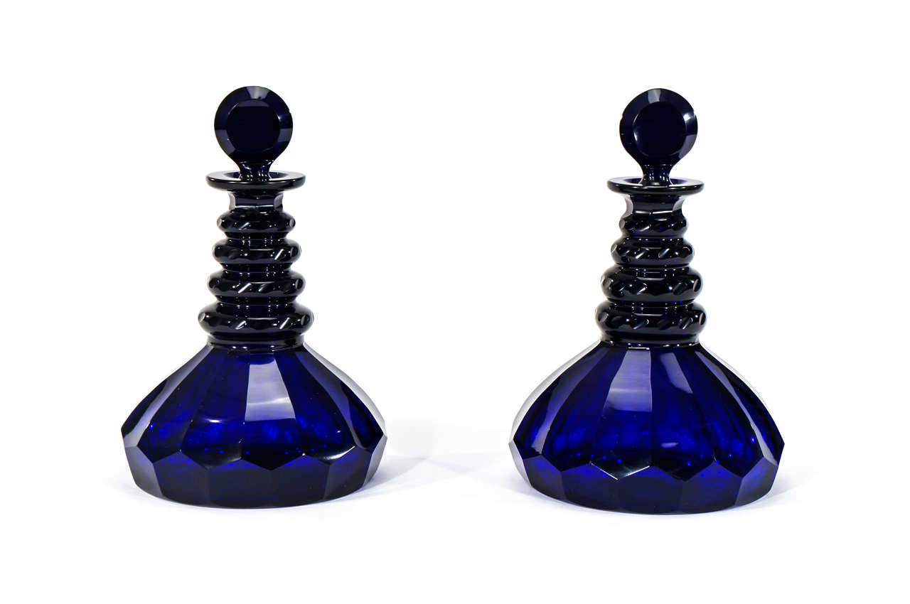 The deep rich blue of these cobalt decanters speak for themselves. The wide bases were designed to create a low center of gravity helping to balance the decanters in rough seas. The clean cutting of the body is facet cut in a "rayed"