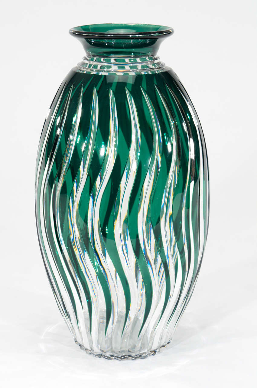 This monumental Val Saint Lambert crystal vase makes quite a sculptural statement with the unusual color of green, its size and fabulous cutting. The undulating rays of green overlay are cut to clear with the 