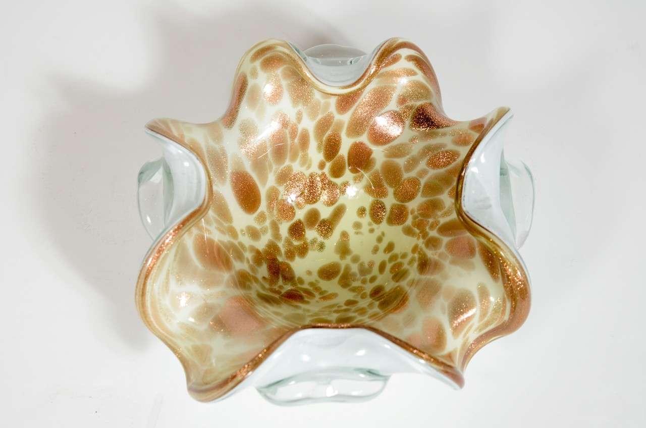 This Mid-Century Murano glass bowl features 24K gold flecks suspended throughout the glass with a tan & caramel mottled interior design & white underside.