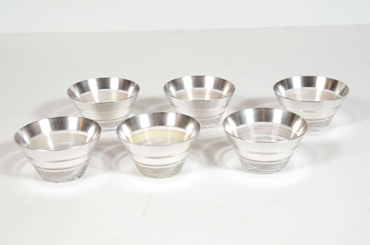 This set of twelve Art Deco glass dessert bowls are conical shaped with concentric banding of sterling silver.