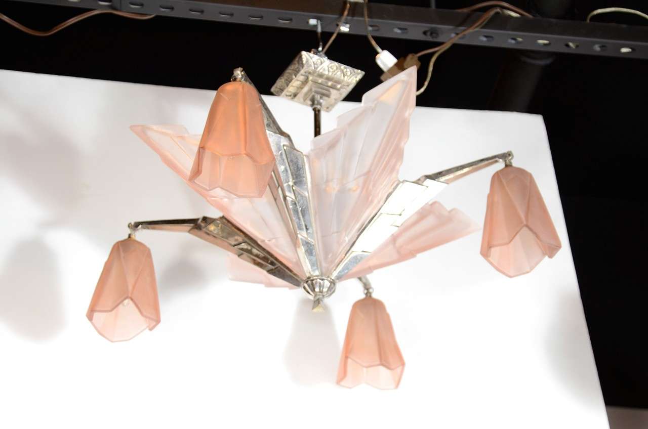This exceptional chandelier by Degue consists of copper relief frosted glass with Art Deco geometric skyscraper  design fittings with glass hanging shades. Newly re-wired.