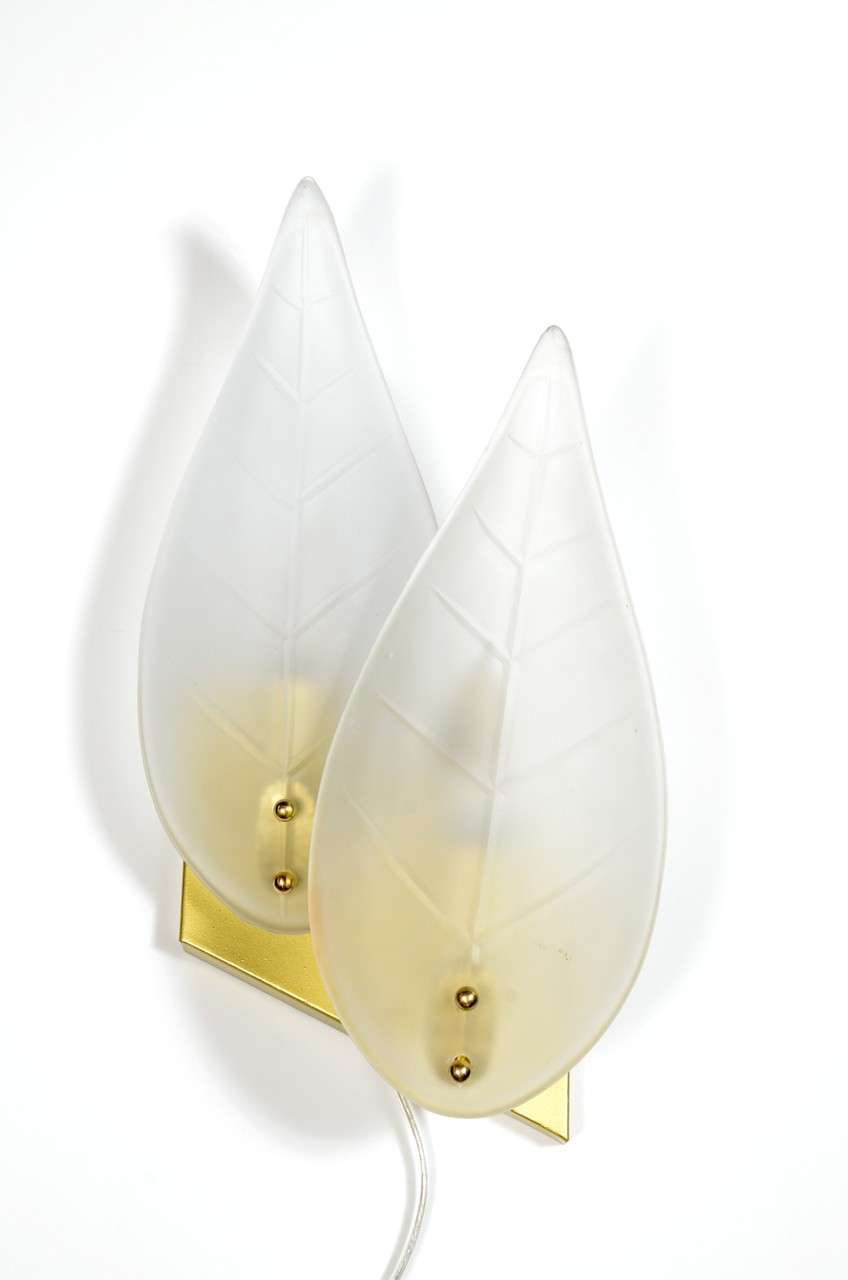 This pair of Mid-Century sconces have a frosted glass double leaf design mounted on gilt fittings with brass details. Each sconce holds two bulbs and has been completely re-wired to American standards. Excellent condition.


