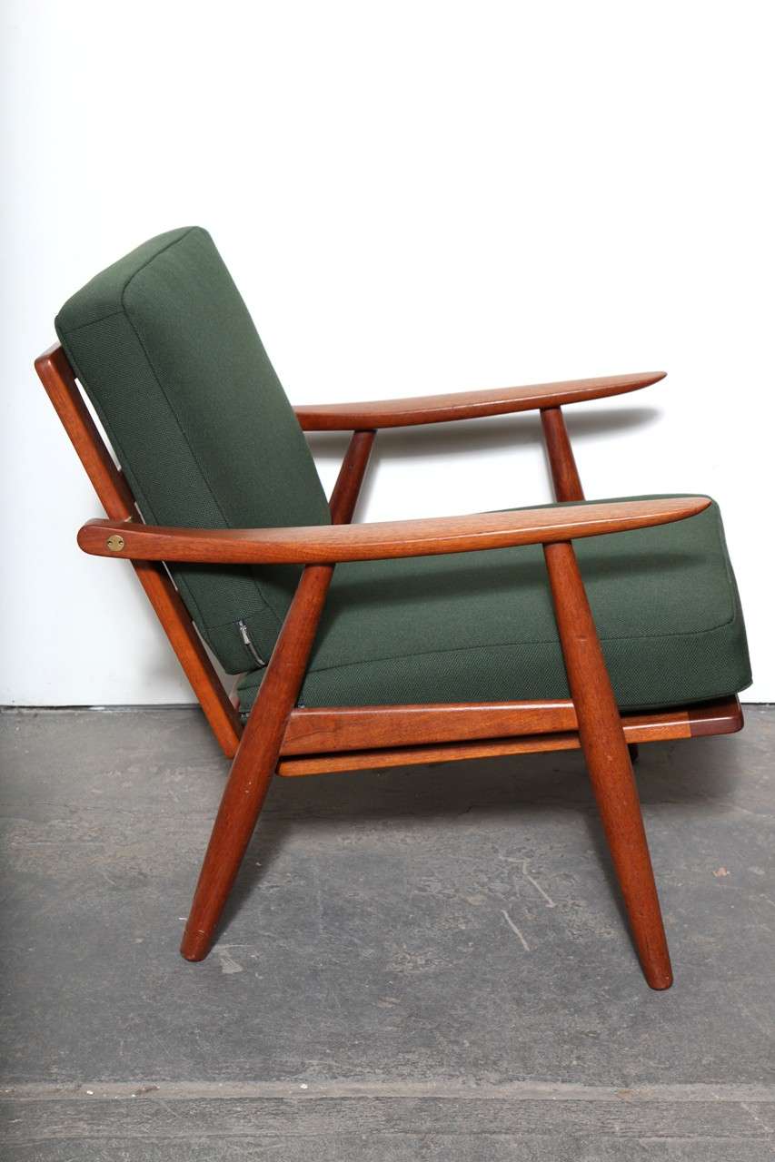 Handsome Pair of Original 1950's Teak GE-270 Danish Lounge chairs by Hans J. Wegner for Getama.  Features solid teak frame, ladderback, sleigh-like arms and brass hardware.  Newly upholstered in a forest green fabric.