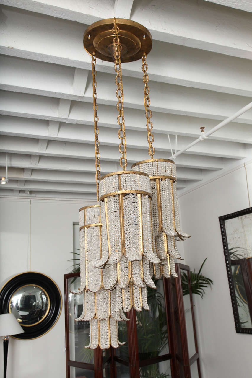 Mid-20th Century beaded crystal and gilt metal chandelier with three hanging 3-tier cylindrical design pendants