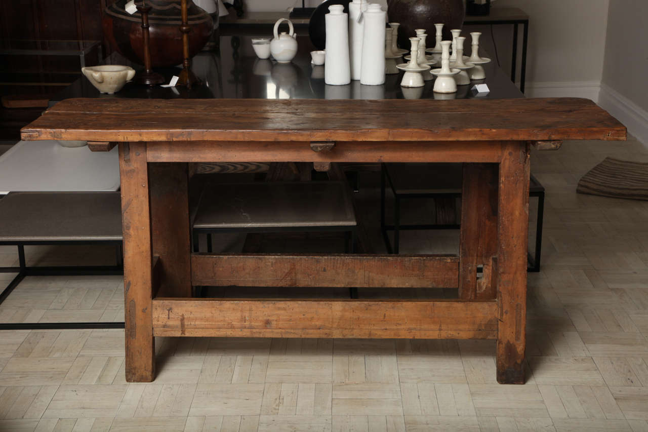 Mid-18th century walnut console table with legs joined by H-stretcher.