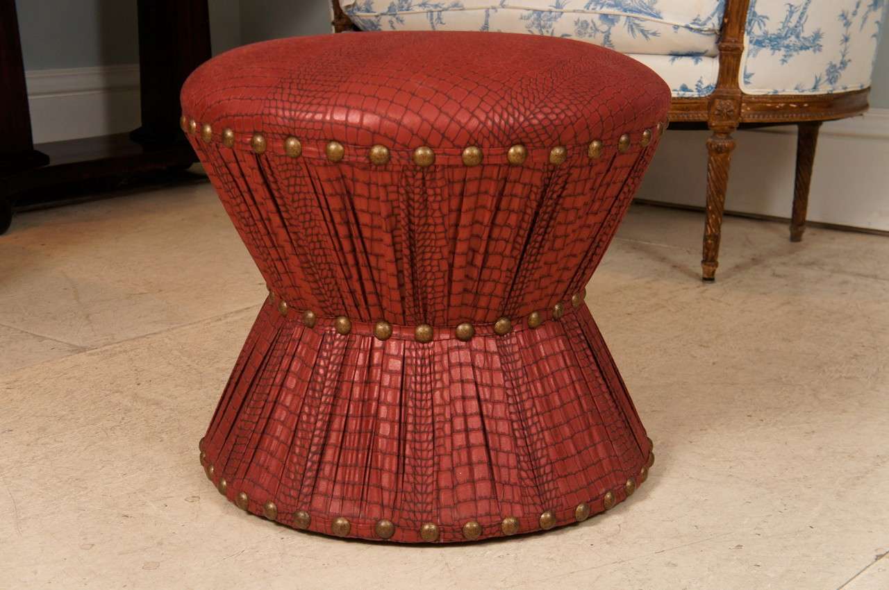 Ruben de Saavedra hourglass stool in embossed leather printed cotton upholstery with brass tacks.