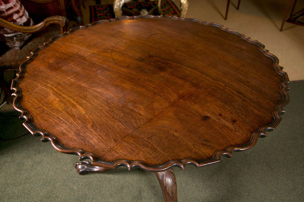 A very rare massive Chippendale carved and figured mahogany pie crust tilt top tea table.  The carving is possibly by Martin Jugiez of Philadelphia and it retains its dark rich historic surface.