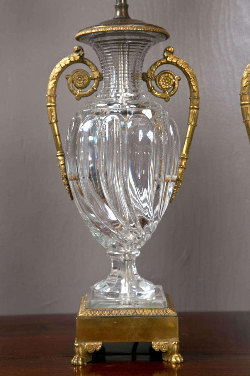 A pair of Continental dore bronze mounted crystal urns mounted as lamps.
