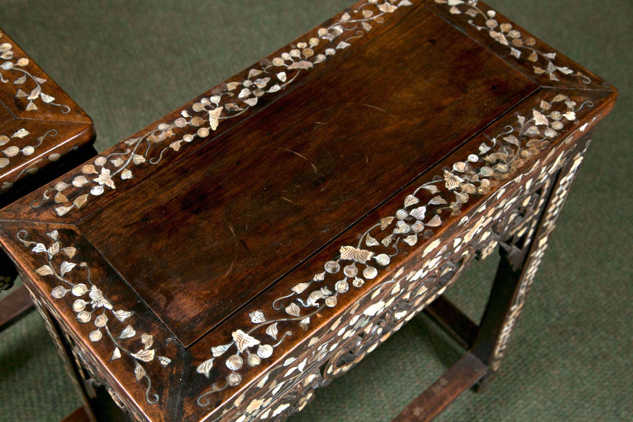 A pair of small Chinese side tables inlaid with mother-of-pearl.