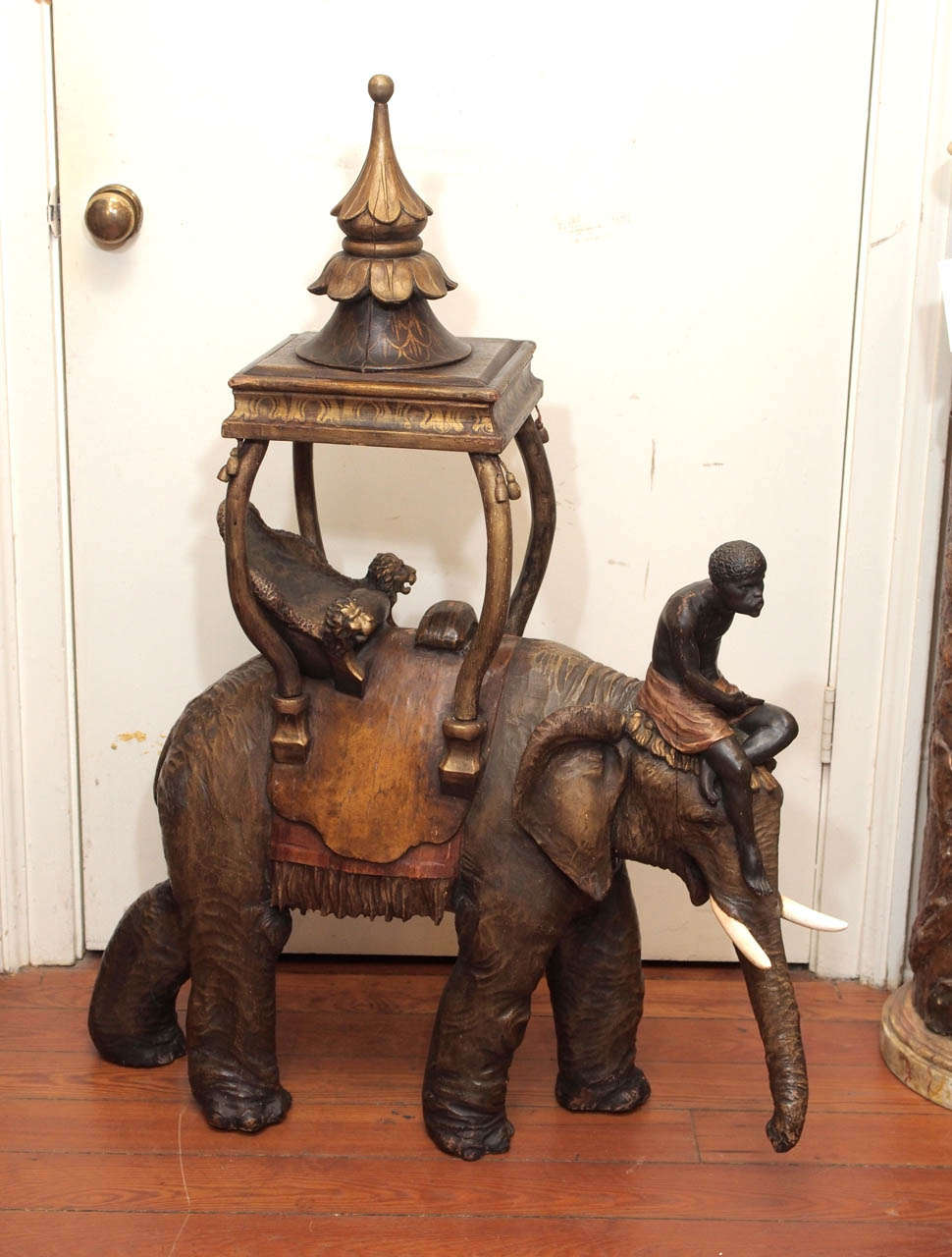 19th c. Polychromed Carved wood elephant with african rider and a gilt seat