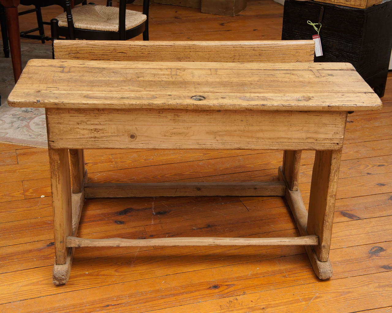 This sturdy and cute little desk came from England, circa 1840. It is the perfect piece for a child's room or family room. It has a nice writing surface, double pencil groove, inkwell and below the top is a shelf for storage.
43 1/2