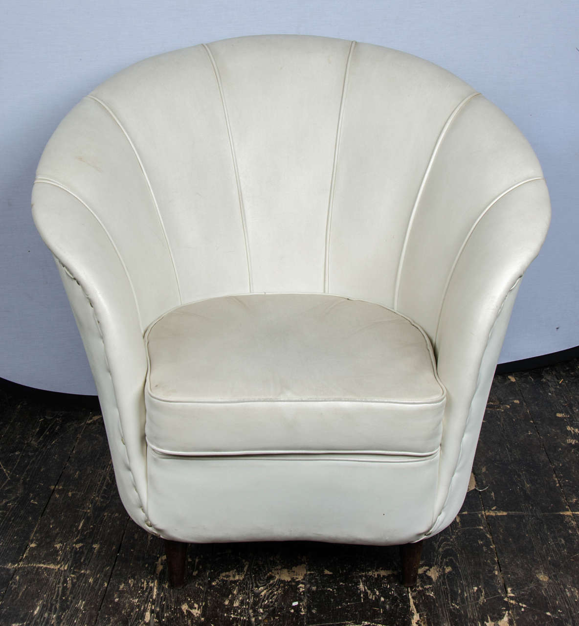 A pair of Italian armchairs in original white leather.