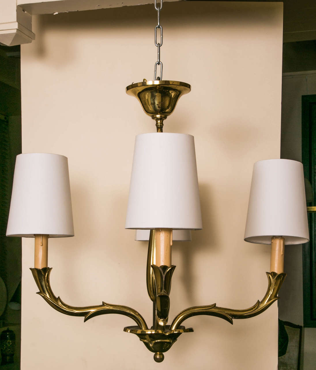 Gilt polished bronze chandelier by Riccardo Scarpa, Italy, 1950s.
With four arms and flower base. Beige candle shafts.
Signed. Measures: Height 19 ¾ x diameter 18 inches.

Riccardo Scarpa (Venice 1905-) was designer and sculptor. He used the