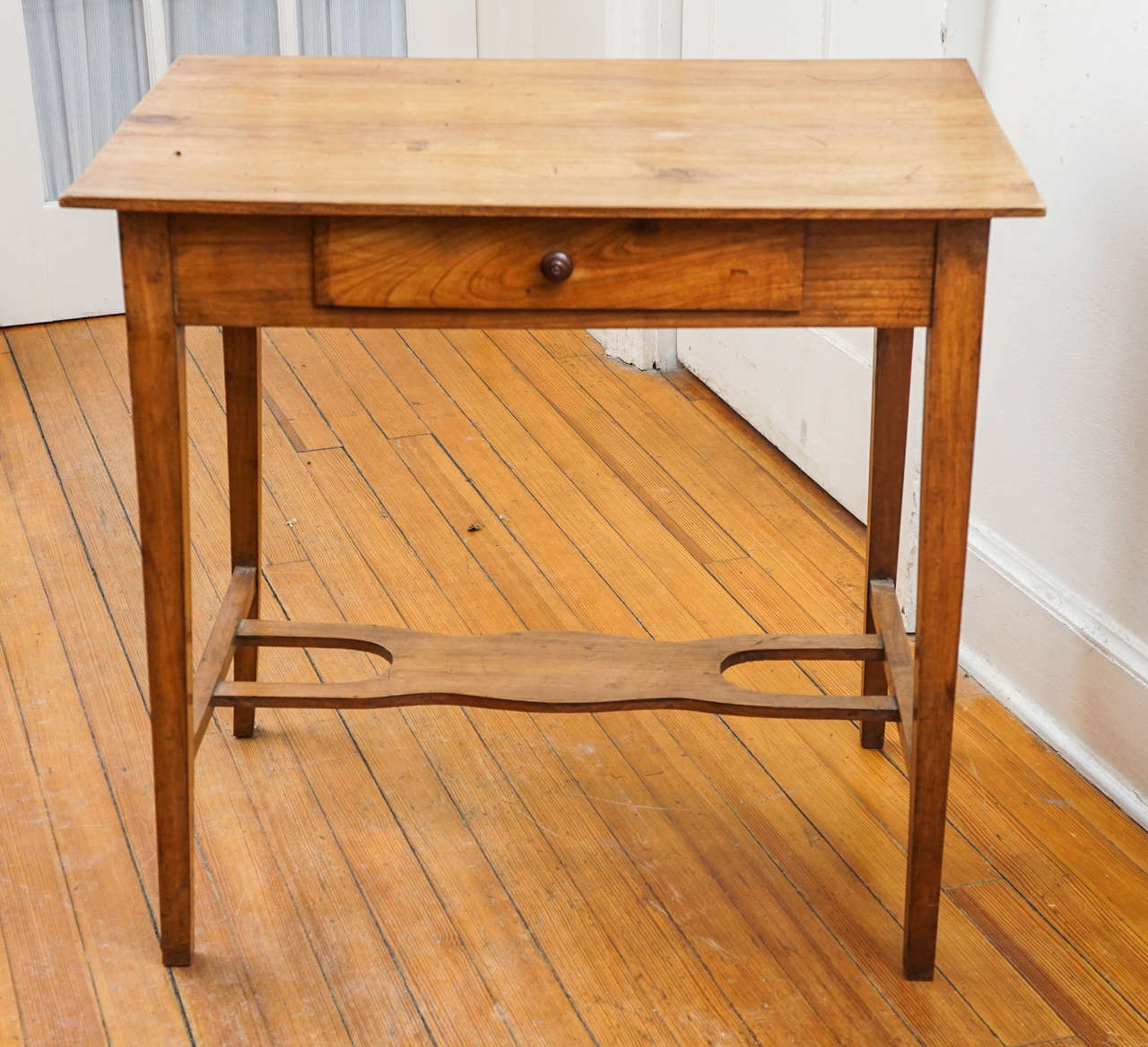 This one-drawer side table is highlighted be an unusual shelf on the bottom and an accent color wooden knob. The size is nothing short of perfect for an end table or a side table and you can't go wrong with fruitwood from France. This is a lighter