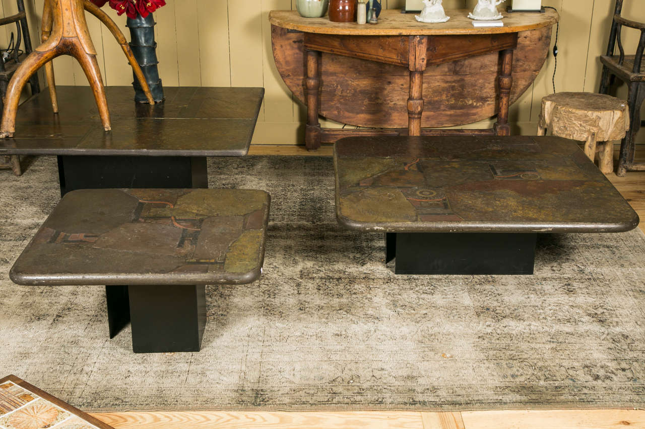 Beautiful landscape pattern created by incrustation of Zimbabwe slate pieces and brass details, into a cement top. 
Uniques signed pieces by the dutsch artist Paul Kingma and his son Mark.
The base is composed of 2 black lacquered metal