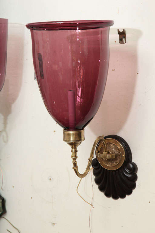 pair of stunning sconces with jewel colored amethyst glass globe