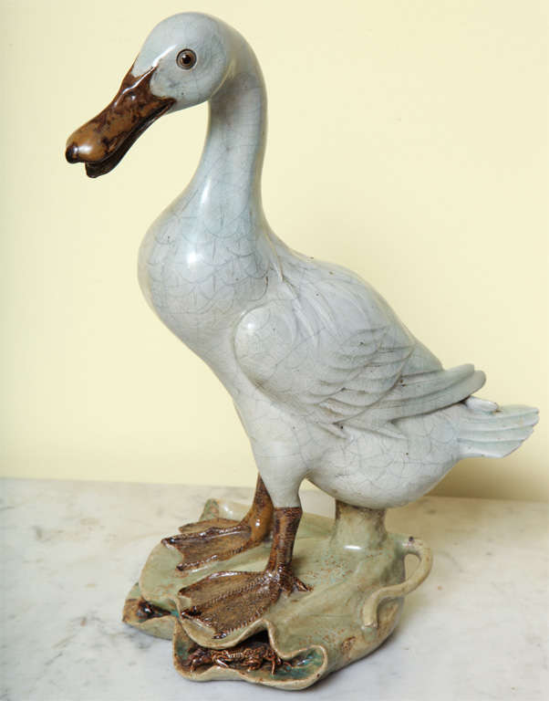 Antique Chinese celadon glazed stoneware duck, the webbed feet standing on a lily pad containing finely modelled crabs, the underside with impressed mark. 19th century