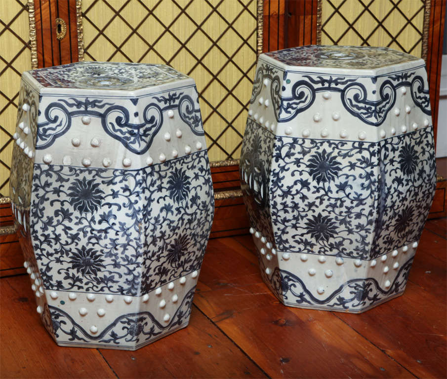 Fine antique pair of hexagonal blue and white porcelain garden seats, having pierced tops and sides and decorated with a meandering foliate and floral design framed top and botton by blue foliate lappets.  Chinese c.1880