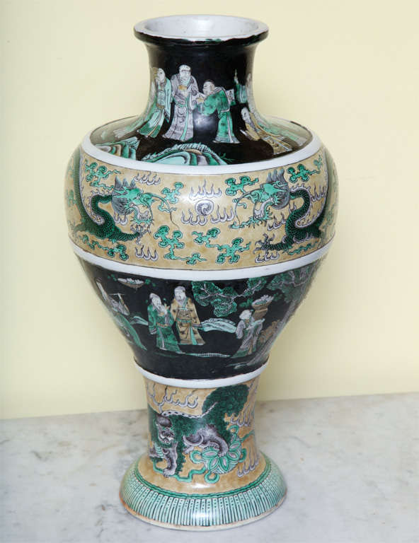 Chinese porcelain baluster form vase in four registers divided by plain white glazed porcelain bands and decorated in a famille noir and famille verte palette, late 19th century.
