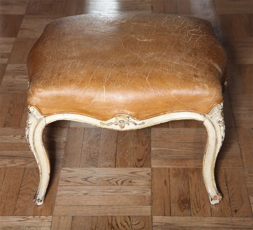 A Louis XV Style Tan Leather and Cream Painted Tabouret