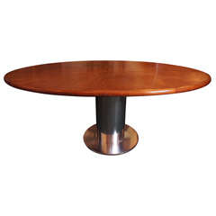 An Oval Bleached Mahogany And Steel Dining Table