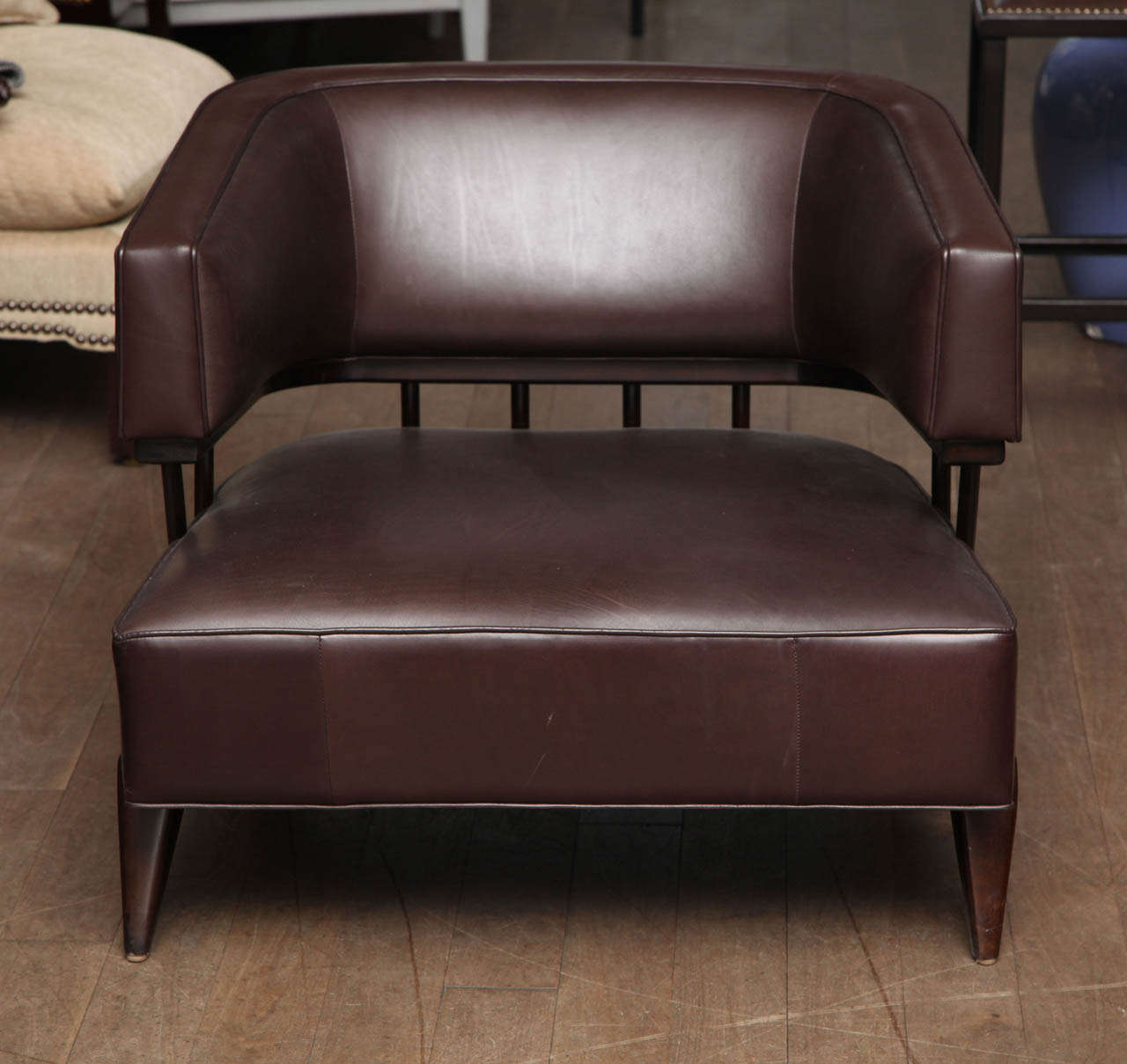 Sable finished club chair circa 1950 upholstered in dark brown leather in the manner of Paul Laszlo