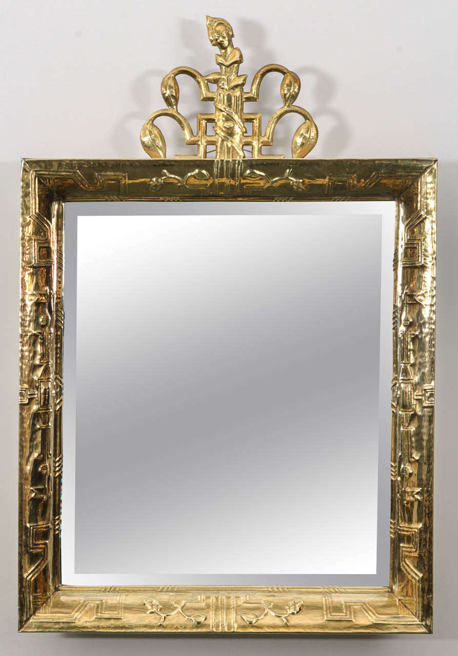 Very rare hammered brass mirror with ornate finial. Austria, 1920's.